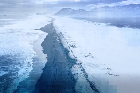 A street in front of the sea with snow